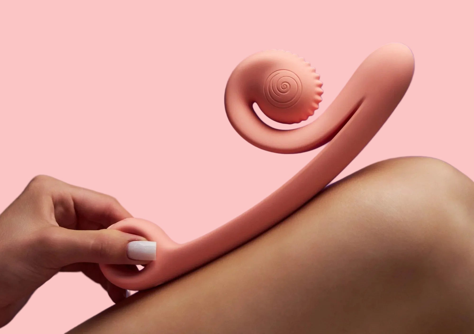 Pink massage tool being used on a leg against a purple background
