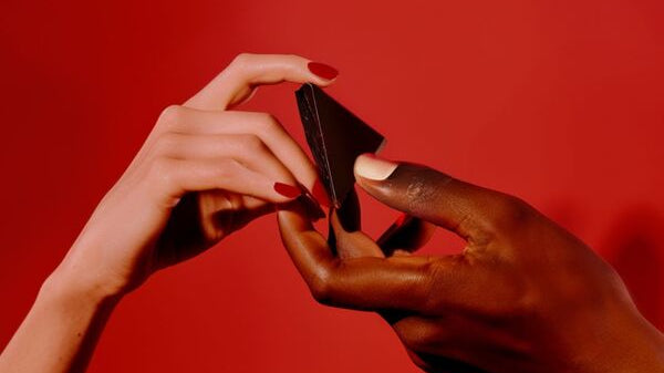 A man and woman share a square of aphrodisiac chocolate