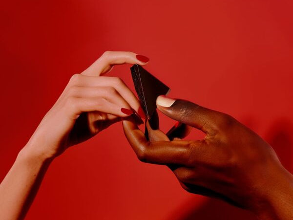 A man and woman share a square of aphrodisiac chocolate