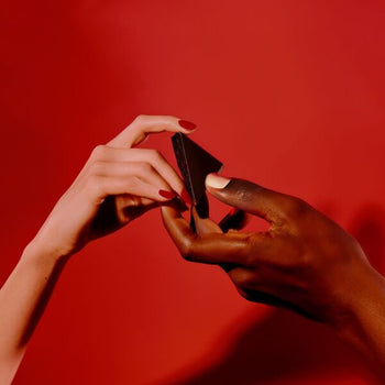 A man and woman share a square of aphrodisiac chocolate